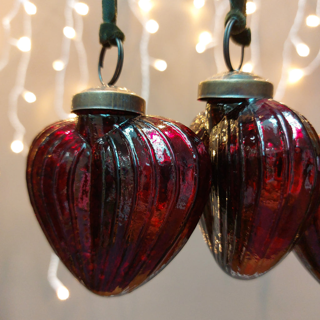 Red heart shaped handcrafted glass bauble with green cotton velvet hanging loop