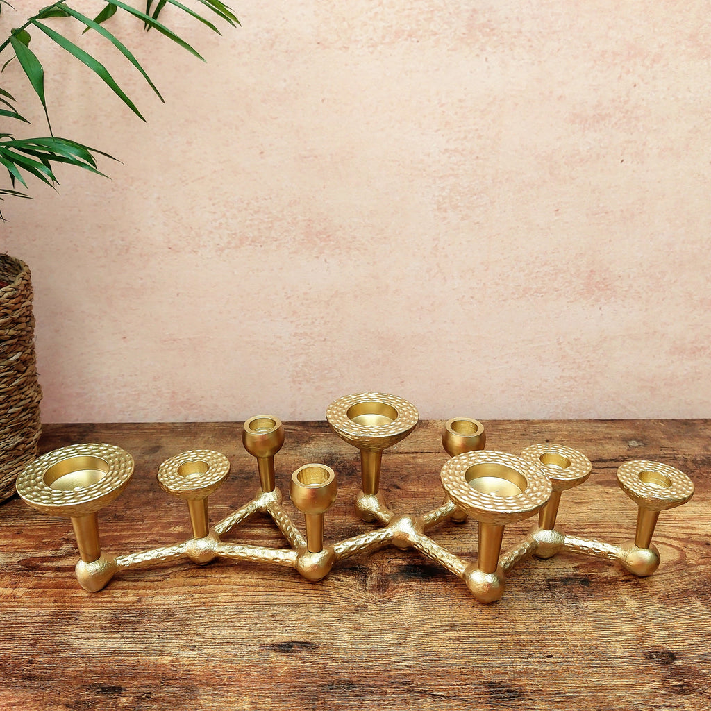 a set of Deeya Multi candle Centrepiece Candelabra on a wooden table.
